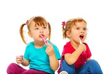 Toddlers brushing teeth