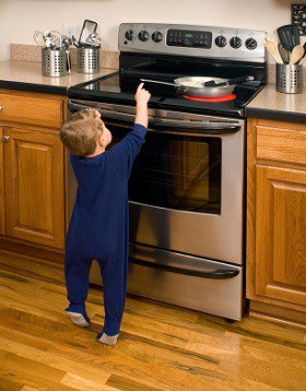 Child touching oven